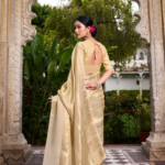 A lady in golden and offwhite combination saree like kerala saree but tissue