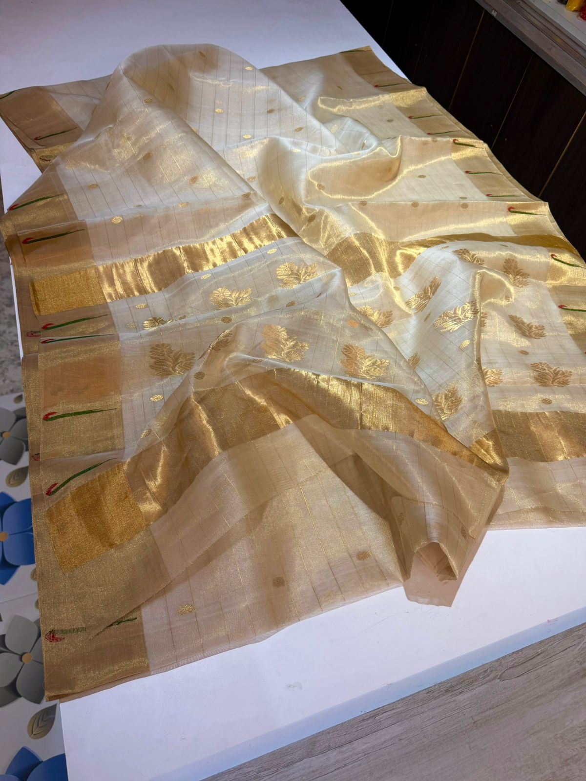 Detailed view of champagne gold Chanderi silk saree with intricate golden leaf weaving and striped pallu.