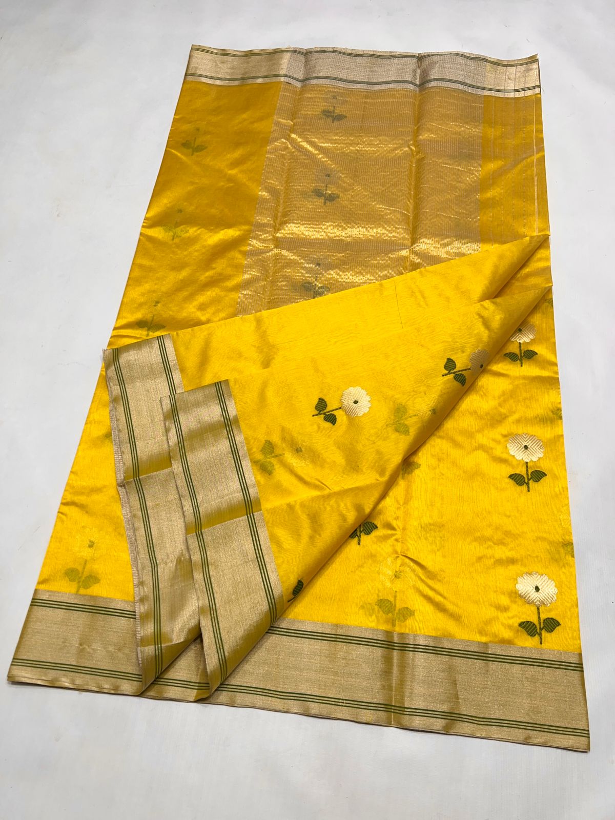 Detailed view of the Sunflower Yellow Chanderi Pattu handloom saree showing the matching blouse piece section and the elegant zari border.
