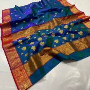 Royal Peacock Blue Chanderi Katan Silk Saree, elegantly draped to highlight the all-over gold coin butti work and the contrast crimson red zari border. Premium wedding handloom