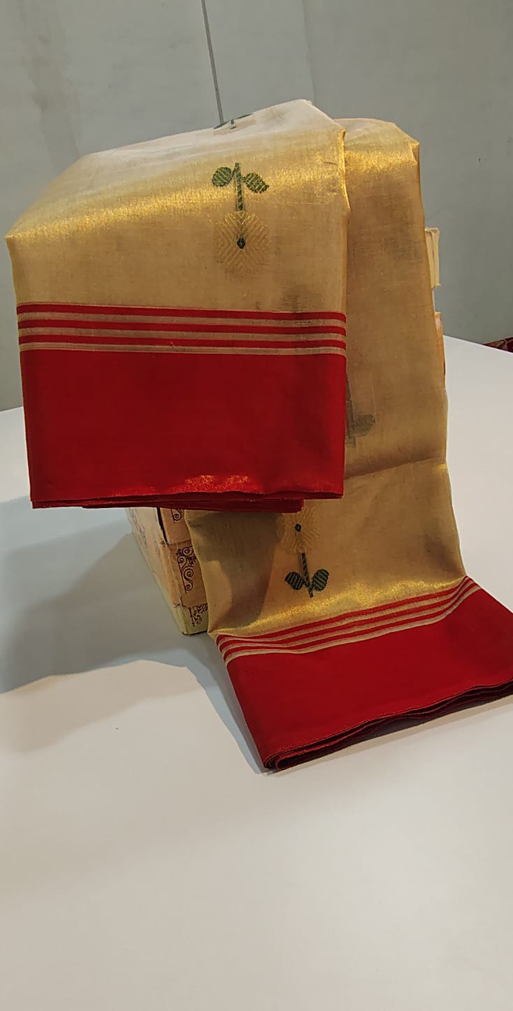 Folded Champagne Gold Chanderi Tissue Silk saree at SareePlus Gallery showing contrast red border and delicate leaf buttis.
