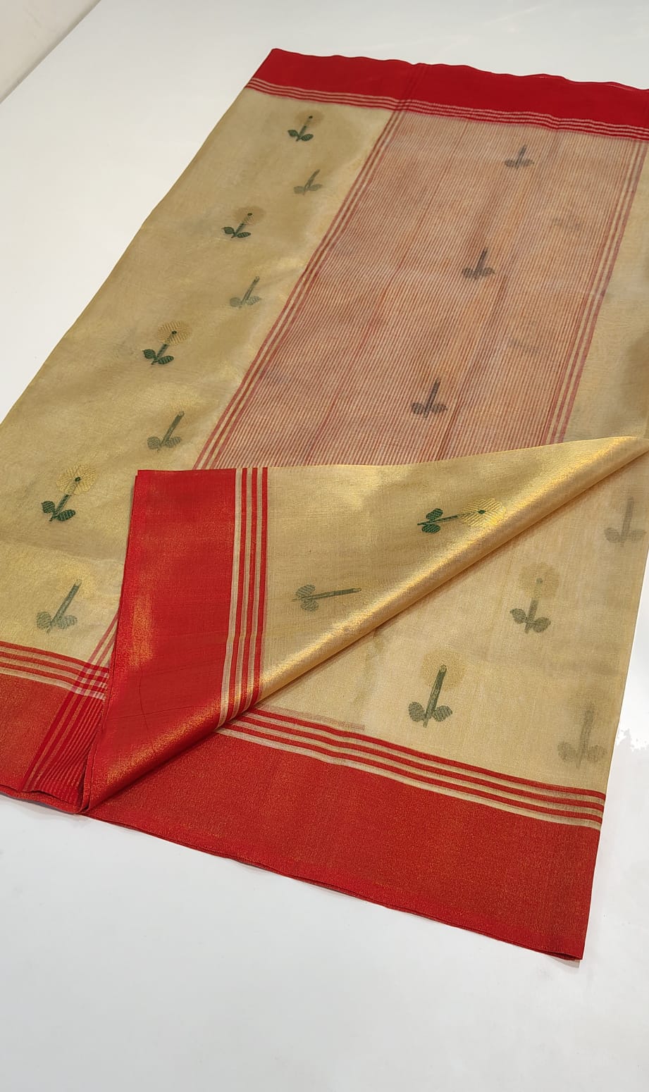 Chanderi Tissue Silk saree in Champagne Gold featuring hand-woven floral motifs, a traditional red zari border, and a matching Champagne Gold tissue blouse piece.